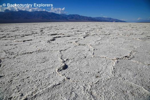 Bawater salt flats with mountains in background